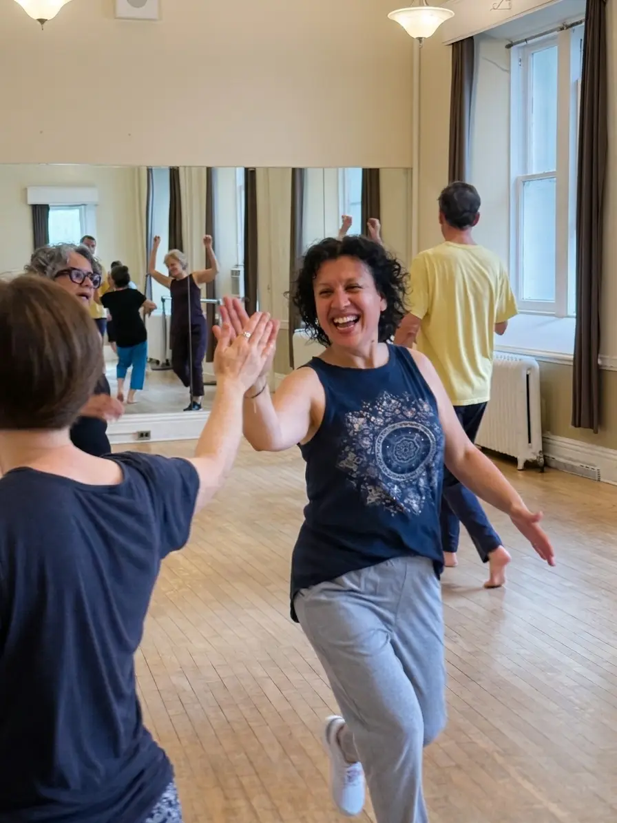 Diana laughing mid-movement in a Biodanza class, arms open among a circle of dancers