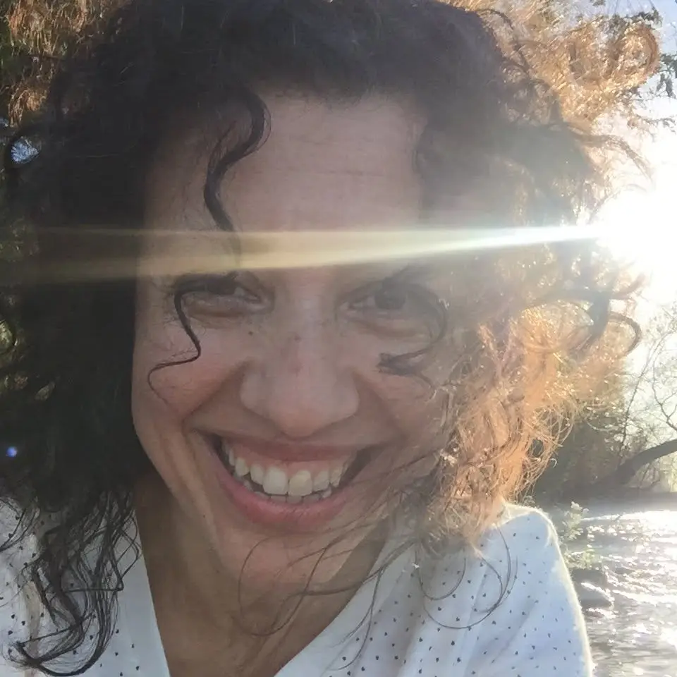 Diana laughing in the sunshine by the water
